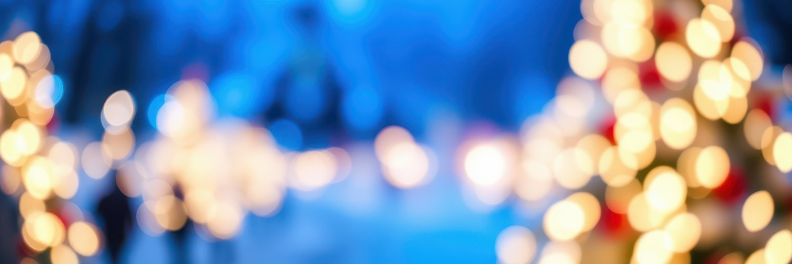 Colorful holiday lights adorn a festive outdoor setting in the evening during winter celebrations